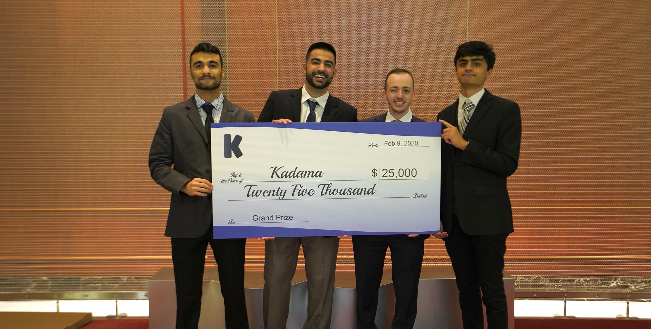 Kadama team holding up a $25,000 check for completing the University of Washington Foster Jones Accelerator